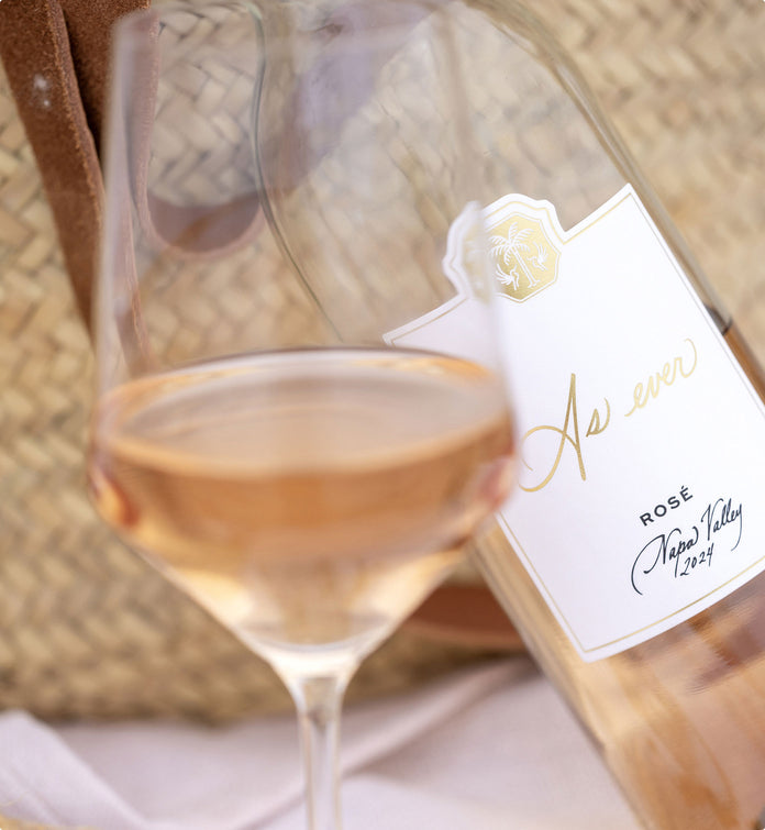 Bottle and glass of As ever Rosé wine on a textured surface