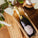 Bottle of As ever Brut in an As ever wooden crate with decorative elements on a wooden surface