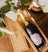 Bottle of As ever Brut in an As ever wooden crate with decorative elements on a wooden surface