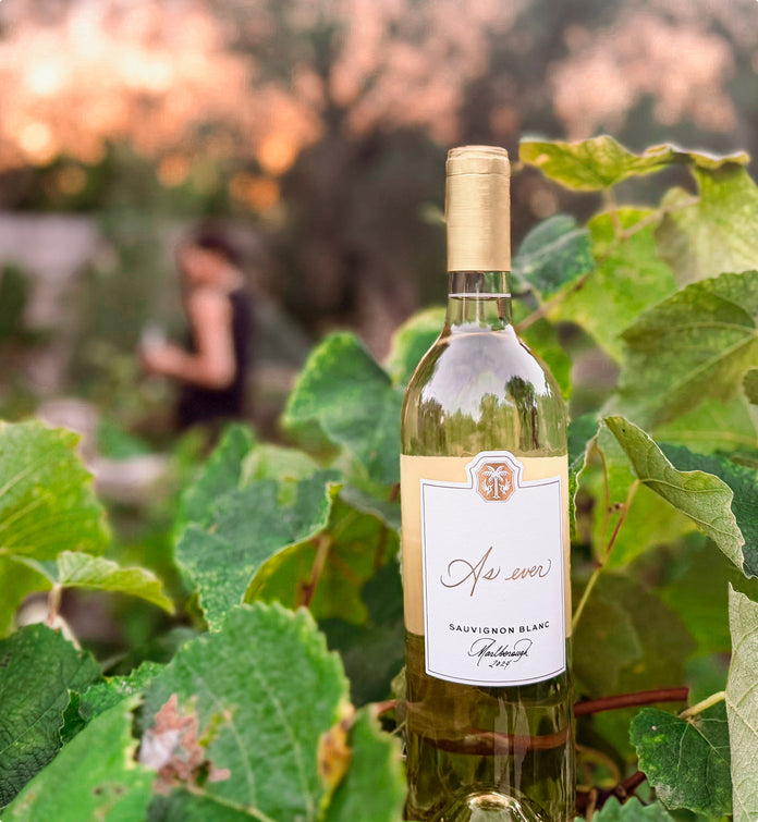 Bottle of As ever Sauvignon Blanc with a label in a vineyard setting