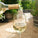 Bottle of As ever Sauvignon Blanc being poured from a bottle into a glass with a garden background